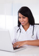 Photo: Happy Female Doctor Using Laptop Happy Female Doctor Using Laptop