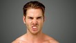 Video: Young man showing his anger on grey background Young man showing his anger on grey background