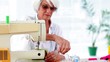 Retired woman using the sewing machine