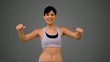 Fit brunette tensing her arms and smiling