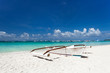 Wooden boat on tropical beach with white sand