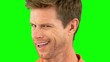 Cheerful man winking an eye on green screen