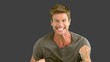 Man showing his happiness on grey screen