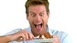 Attractive man about to eat a cake on white screen