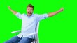 Man sitting on swivel chair with raised arms to show his success