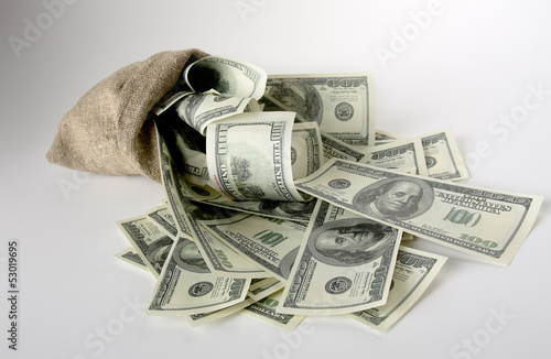 Photo: Canvas money sack with one hundred dollar bills Canvas money sack with one hundred dollar bills