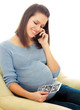 Portrait of a young pregnant girl on a light background