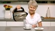 Retired woman pouring boiling water