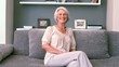 Retired woman laughing on the couch