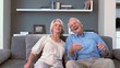 Retired couple flopping down on the couch