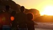 Silhouettes of friends relaxing while looking at the sunset