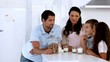 Family chatting and having cookies and milk
