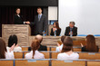 Photo: Business people at tribune in conference room Business people at tribune in conference room