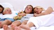 Parents dozing with their children