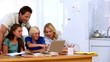 Family using the laptop together to do homework