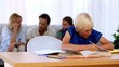 Video: Son doing his homework with family on couch behind Son doing his homework with family on couch behind