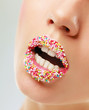 close up of woman lips with multicolored pearls