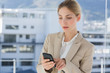 Businesswoman touching the screen of her smartphone