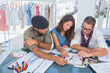 Three fashion designers working in a bright office