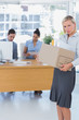 Forlorn businesswoman leaving office after being let go
