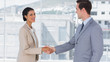Businesswoman shaking hands to businessman