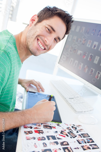 Photo: Photo editor working with a graphics tablet Photo editor working with a graphics tablet