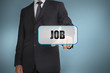 Foto: Businessman touching tag with job written on it Businessman touching tag with job written on it