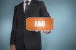Businessman selecting orange tag with the word faq written on it