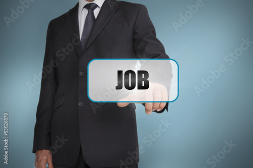 Photo: Businessman touching tag with job written on it Businessman touching tag with job written on it