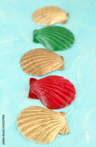 Photo: Colorful seashells on color wooden background Colorful seashells on color wooden background