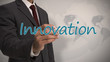 Photo: Businessman writing the word innovation Businessman writing the word innovation
