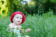 cute little girl sitting in the green field
