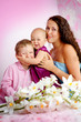 Happy family mother and her children boy and girl sitting indoor