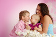 Happy family mother and her children boy and girl sitting indoor