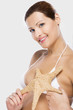 Beautiful woman holding a starfish