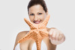 Photo: Beautiful woman holding a starfish Beautiful woman holding a starfish