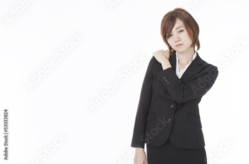 Photo: businesswoman suffering from shoulder stiffness businesswoman suffering from shoulder stiffness