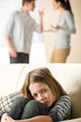 Fighting parents and sad little girl