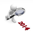 Man with magnifying glass and 2014 on background