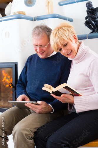 Photo: Seniors at home in front of fireplace Seniors at home in front of fireplace