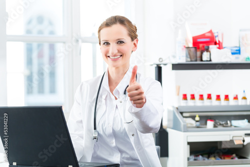 Photo: Female doctor writing on Pc in her clinic Female doctor writing on Pc in her clinic