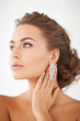woman wearing shiny diamond earrings