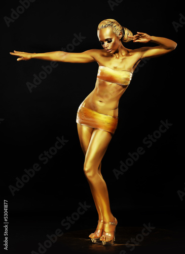Photo: Radiance. Fantasy. Golden Woman Performing in Night Club. Lights Radiance. Fantasy. Golden Woman Performing in Night Club. Lights