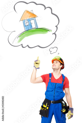 Photo: Worker with tools points on house Worker with tools points on house