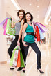 Photo: Young adult girls with shopping bags at shop Young adult girls with shopping bags at shop