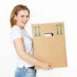 Photo: Pretty young woman carrying a moving box Pretty young woman carrying a moving box
