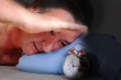 Man can not sleep and looked at the alarm clock
