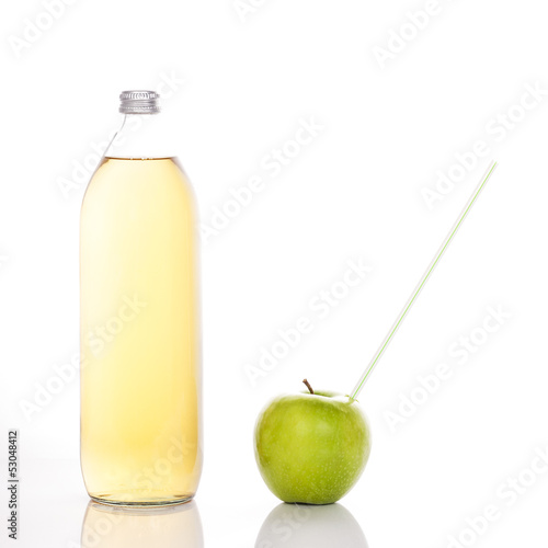 Photo: juice in a glass bottle and green apple juice in a glass bottle and green apple