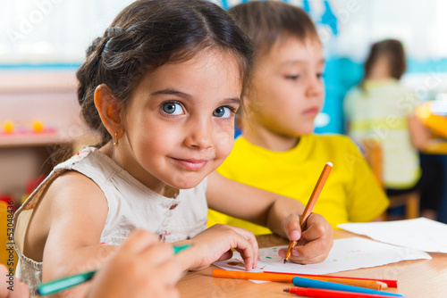 Photo: Group of cute little prescool kids drawing Group of cute little prescool kids drawing