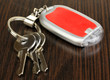 Photo: House keys and keychain on wooden background House keys and keychain on wooden background
